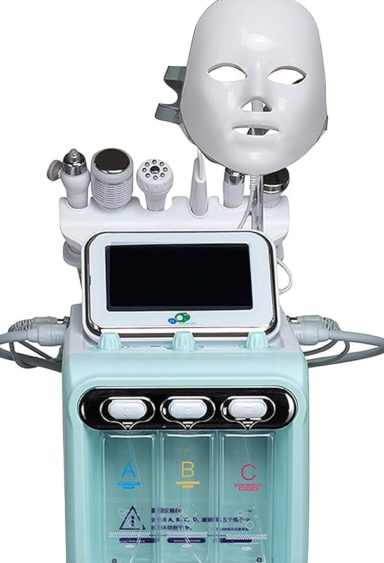 Skincare machine with various attachments and a facial mask atop a digital display.