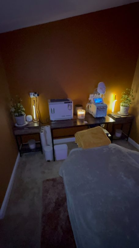 A calming therapy room with a massage table and soothing lighting.