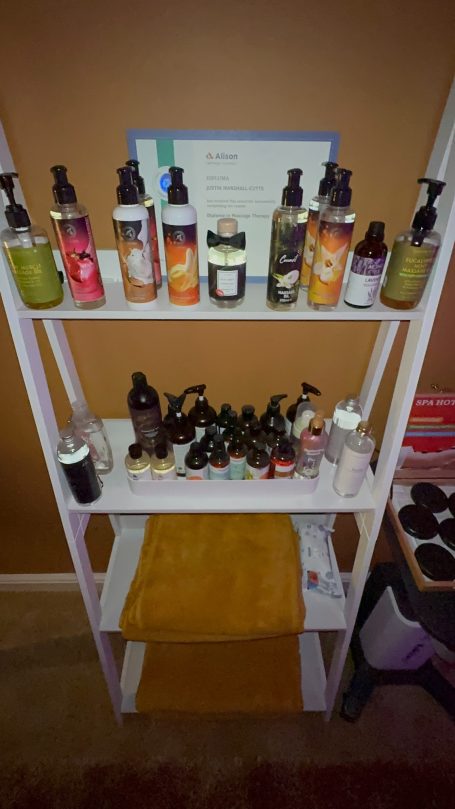 Shelving unit displaying various bottles of skincare and beauty products.