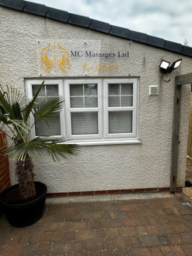 Exterior of a building featuring a sign for "M&J Management Ltd" and a palm tree.